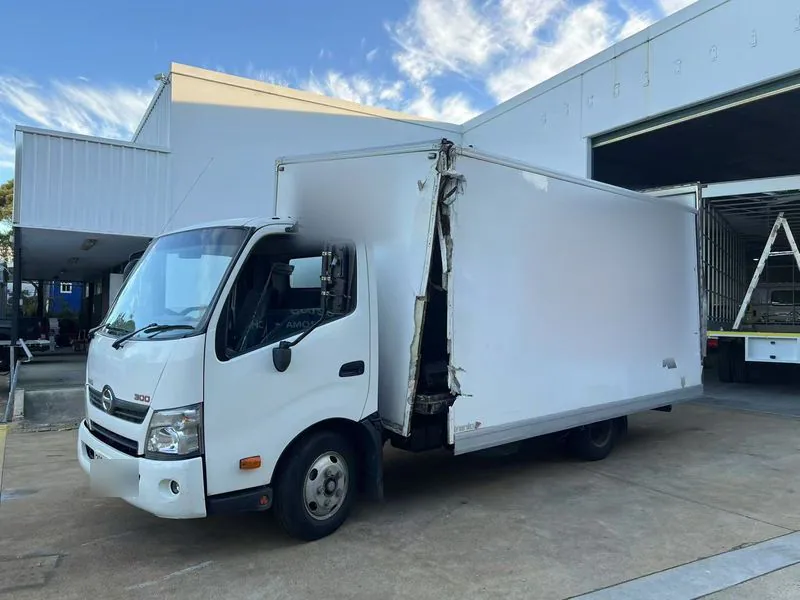 Damaged enclosed truck body before Kirin repair