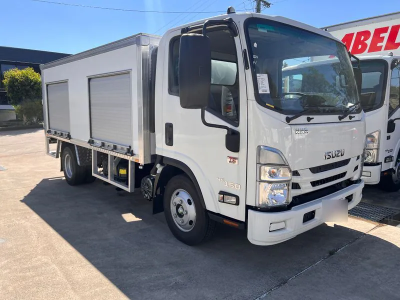 Battery service truck showing three side roller-door compartments