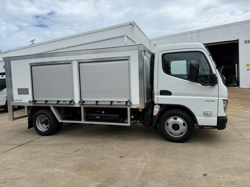 Side profile of lightweight battery service truck body with roller doors